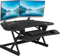 Rocelco 46' Height Adjustable Corner Standing Desk Converter with AC Outlet and USB Charger - Sit Stand Up Dual Monitor Tabletop Riser Workstation - Large Keyboard Tray - Black (R CADRB-46-ACUSB)