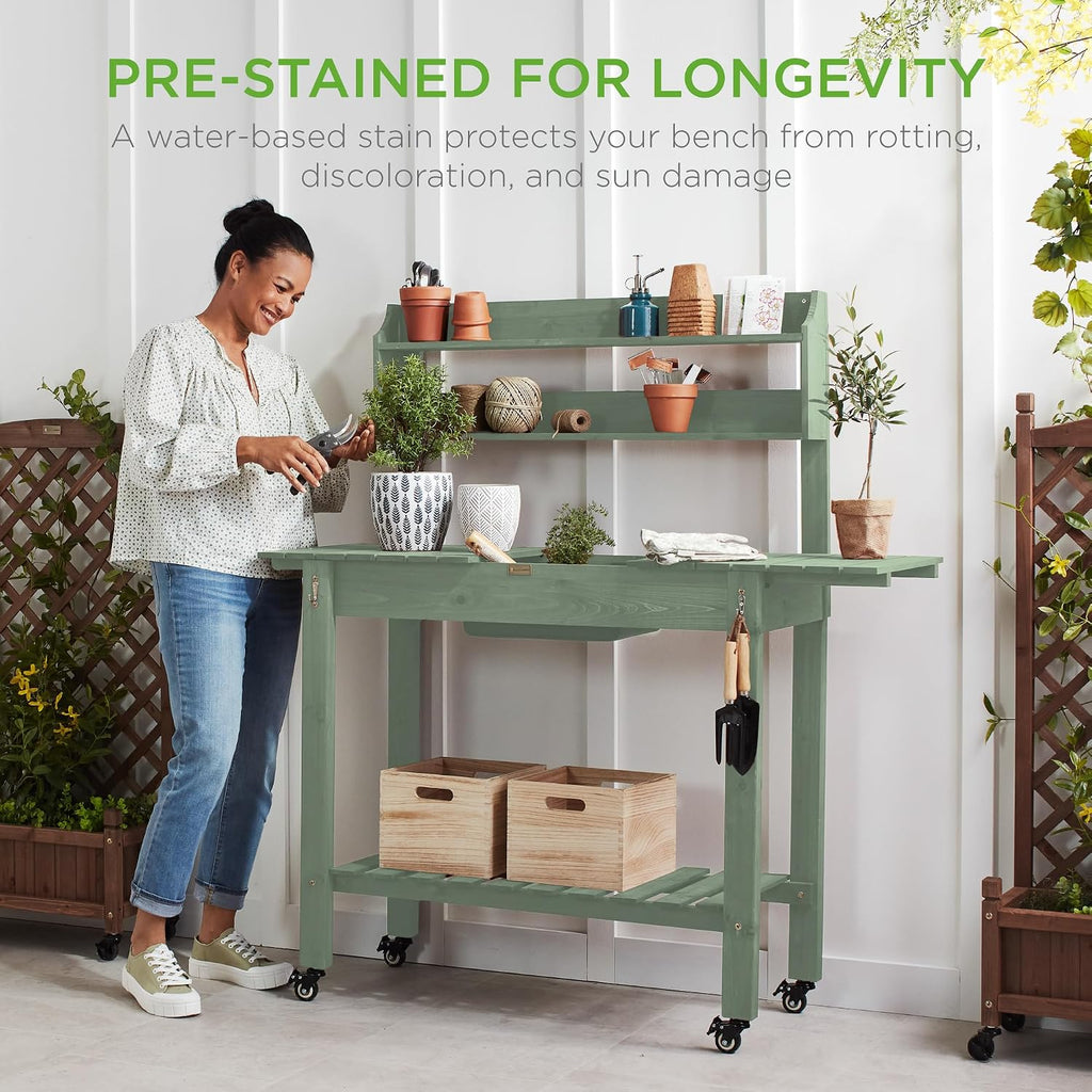 Best Choice Products Mobile Garden Potting Bench, Outdoor Wood Workstation Table w/Sliding Tabletop, 4 Locking Wheels, Food Grade Dry Sink, Storage Shelves - Sage Green